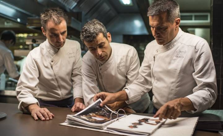 Los tres cocineros y socios (de izquierda a derecha: Eduard Xatruch, Mateu Casañas y Oriol Castro) revisan los platos que han creado.