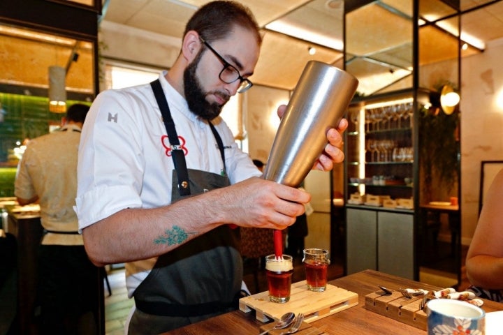 Víctor sirve su particular "vermú": té negro con panela, fermentado con kombucha y aromáticos de vermú.