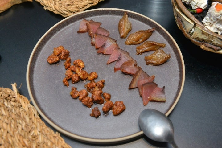 Toppings de bonito curado, molleja de cerdo crujiente y cebolla fermentada en miel.