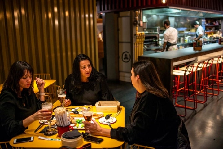 Las mesas de 'Arallo Taberna' comparten espacio con la barra-cocina, que es casi un escenario.