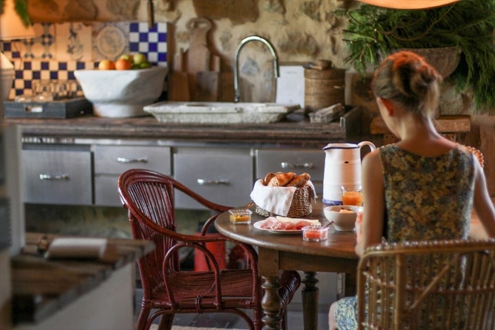 Chica desayunando en la cocina del hotel.