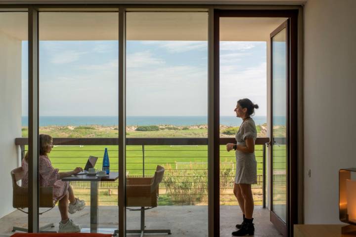 Dos mujeres disfrutan de las vistas desde la terraza de una de las habitaciones del parador.