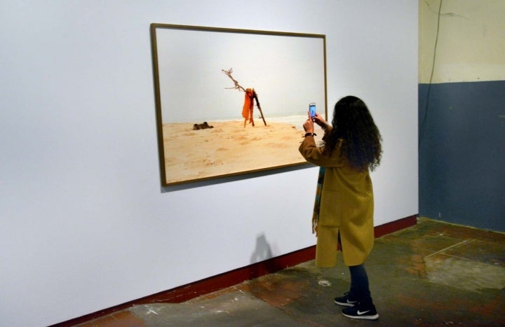 Una mujer observa las obras de Khamekaye