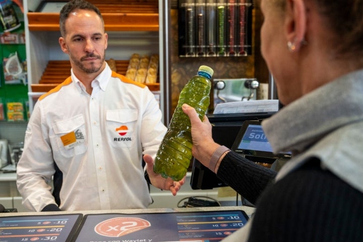 Entrega de botella con aceite de cocina usado en la estación de servicio de Coirós (A Coruña)