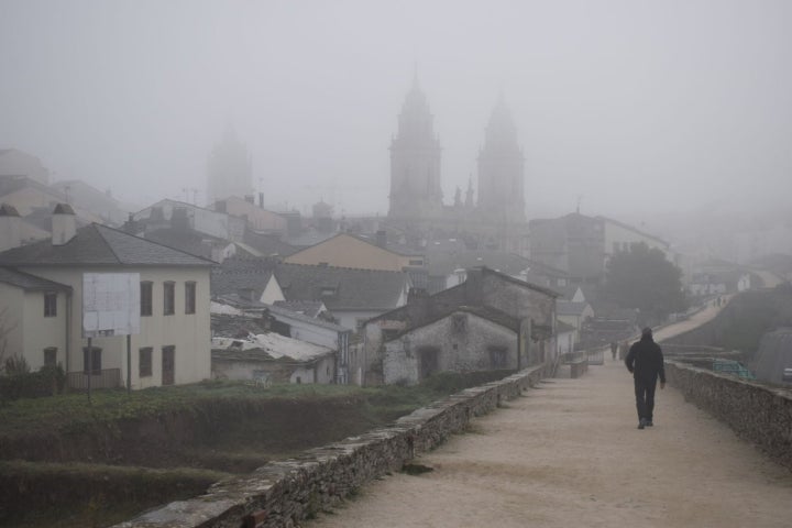 La muralla romana de Lugo, del siglo II y la mejor conservada en España, rodea el casco histórico con su más de 2.000 metros. Al fondo, el perfil de la catedral. Foto: Shutterstock.