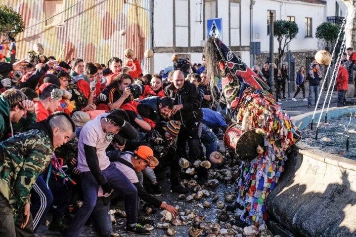 El Jarramplas acorralado en la fuente de una de las plazas del municipio.