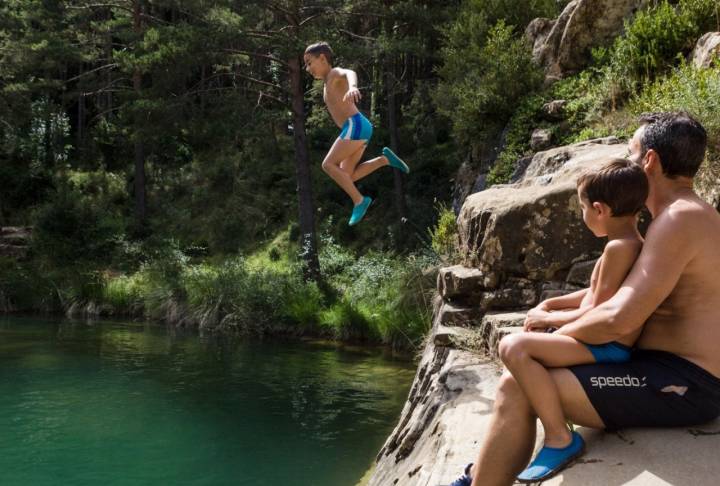 Piscinas naturales río Arba de Luesia: un niño saltando en el pozo Pigalo