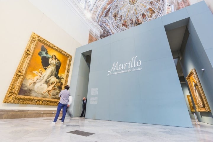 Un hombre observa una Inmaculada de Murillo en el Museo de Bellas Artes de Sevilla.