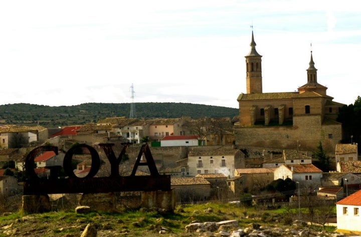 Entrada al pueblo de Fuendetodos con su iglesia a la derecha. Fotografía: Cortesía del Ayuntamiento de Fuendetodos.